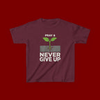 Kids Tee – "Pray & Never Give Up" Inspirational Plant Graphic